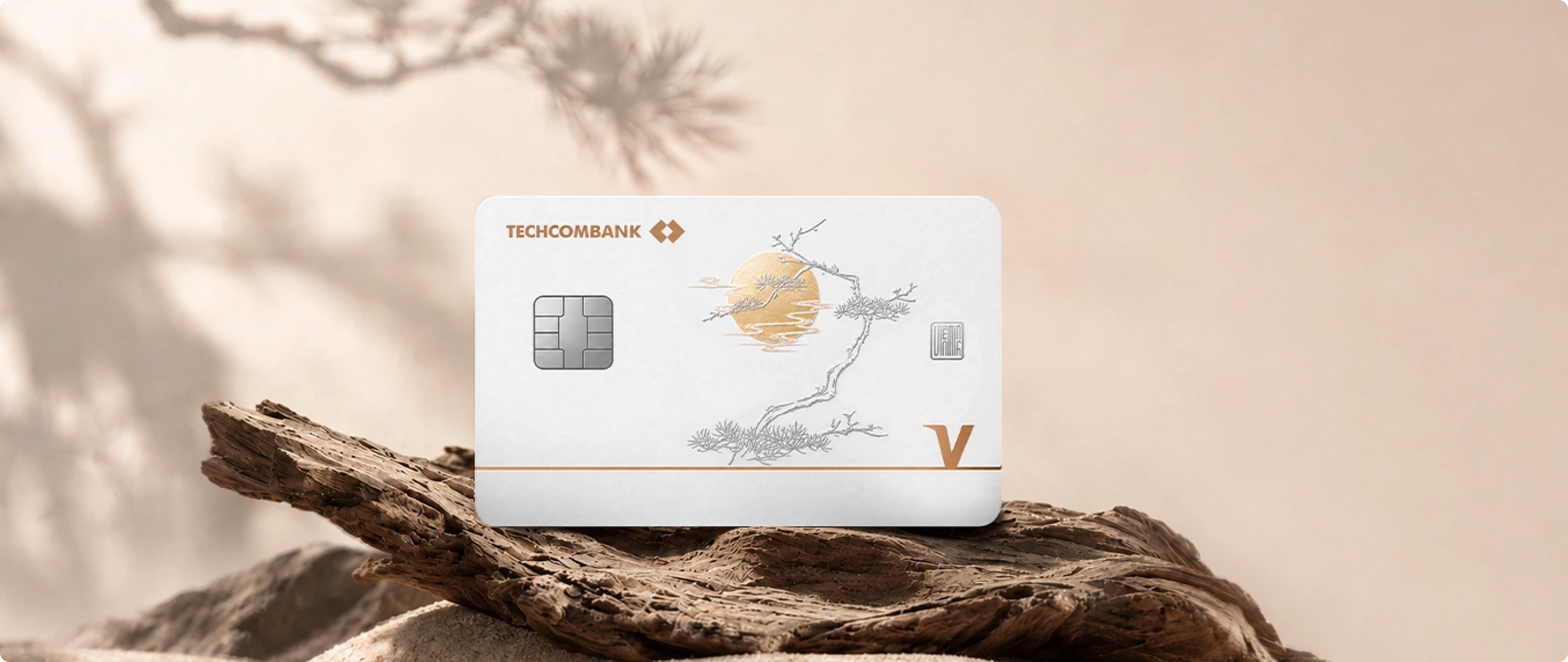 Two TechcomWealth Visa Infinite Private cards against a bamboo and gold-lit architectural backdrop